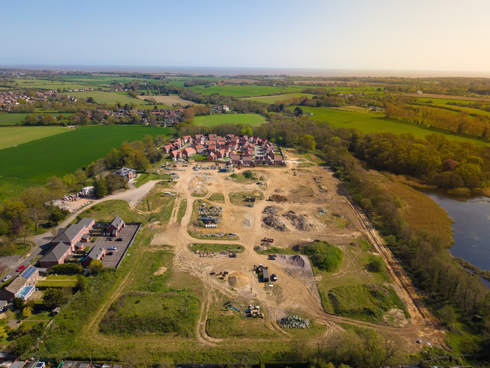 Aerial view of a housing development with plots being built out — plot sales solicitors for developers in Norfolk and Suffolk