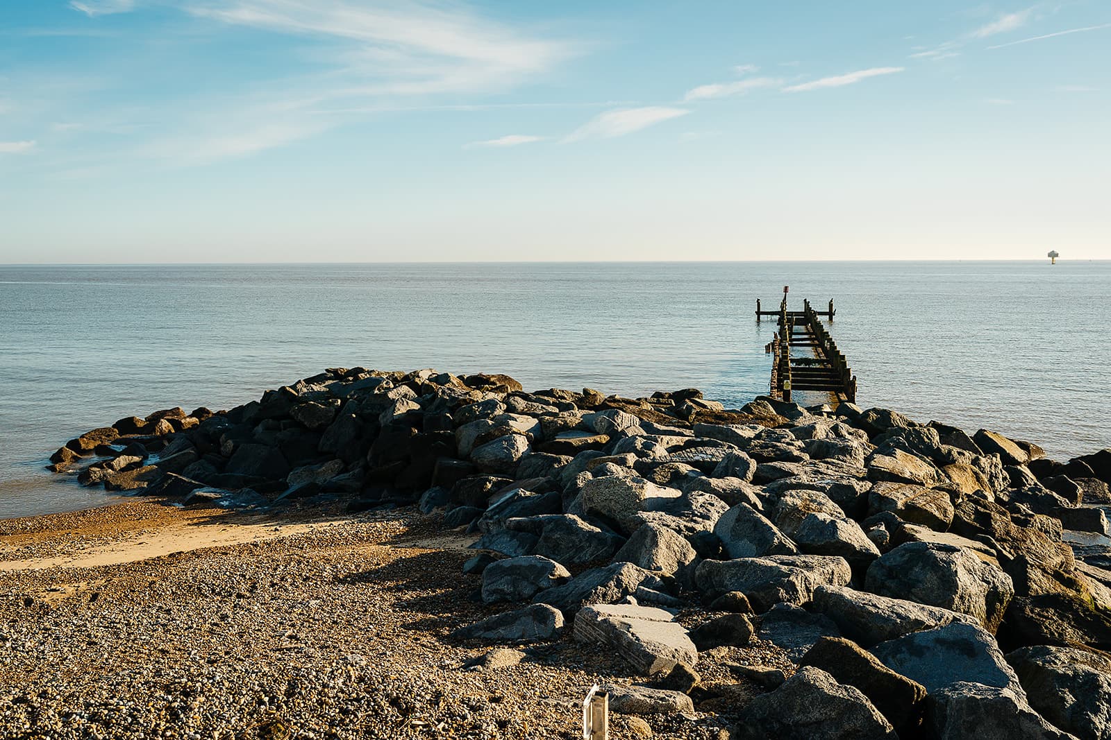 The rock groyne and old wooden jetty on Lowestoft beach at low tide — whether you can get divorced online